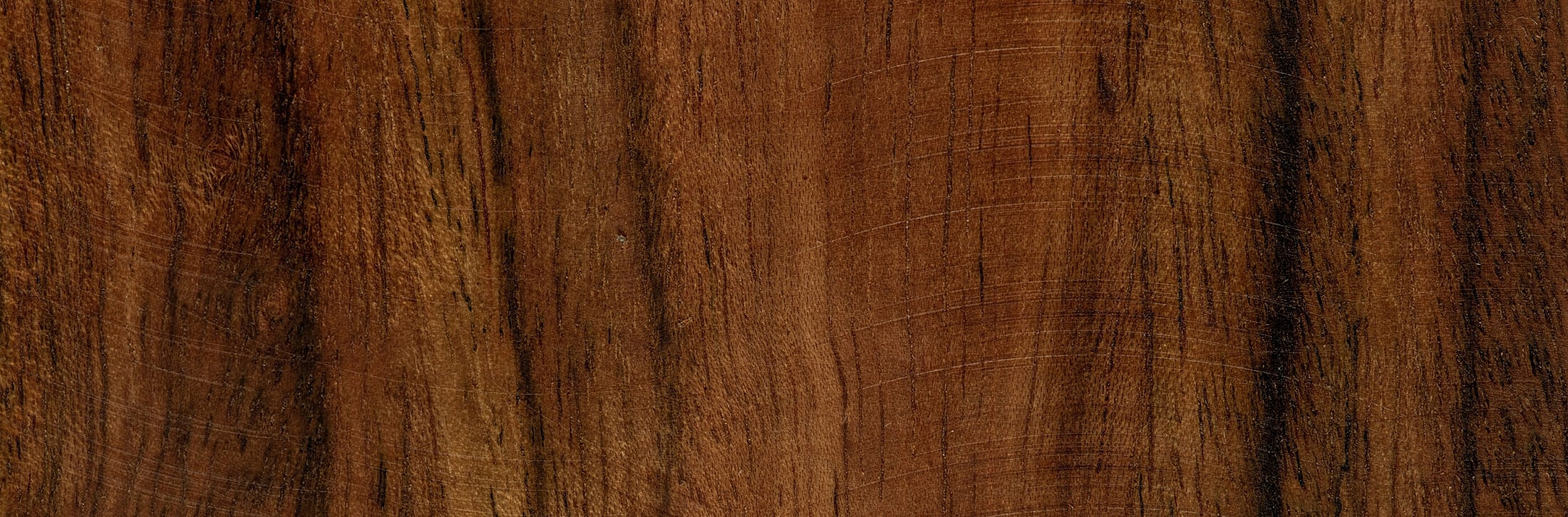 Smooth wood surface with rich brown tones.