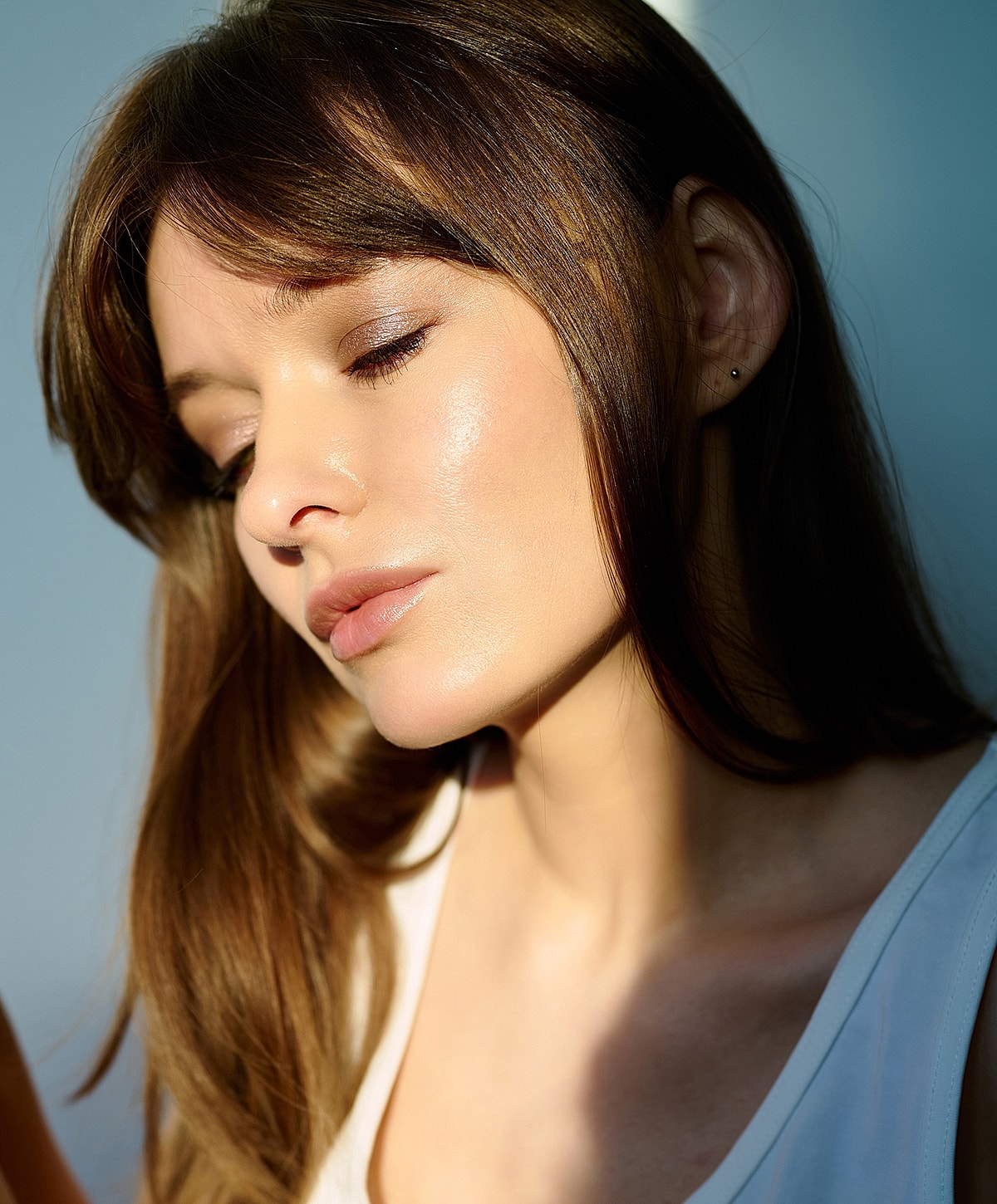 Woman in white lace lingerie near window.
