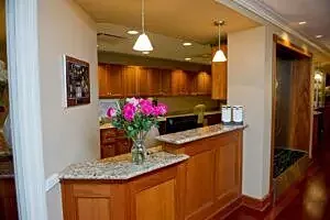 Reception area with flowers and wooden cabinetry.