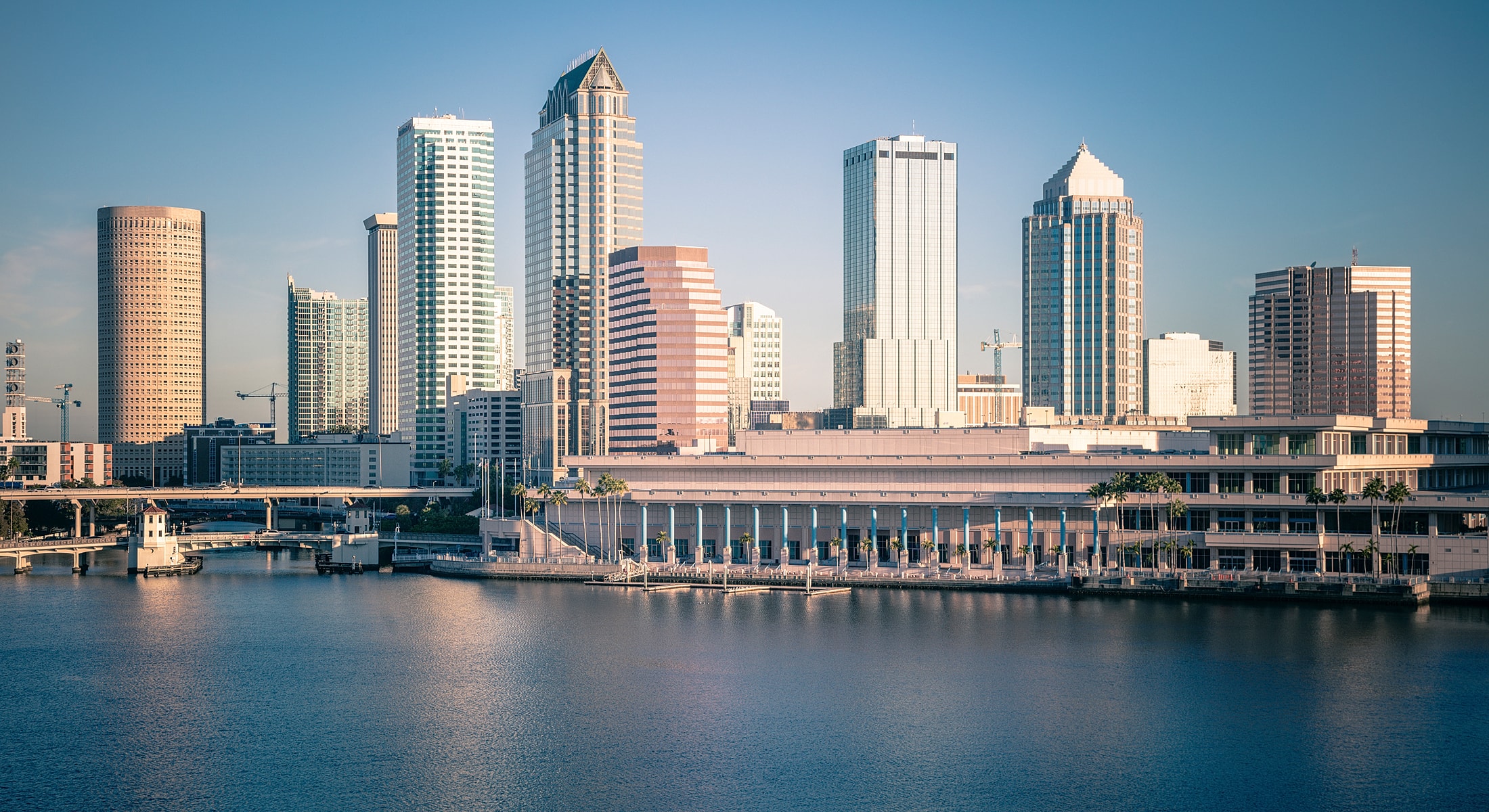 Tampa skyline reflecting in water at sunset.
