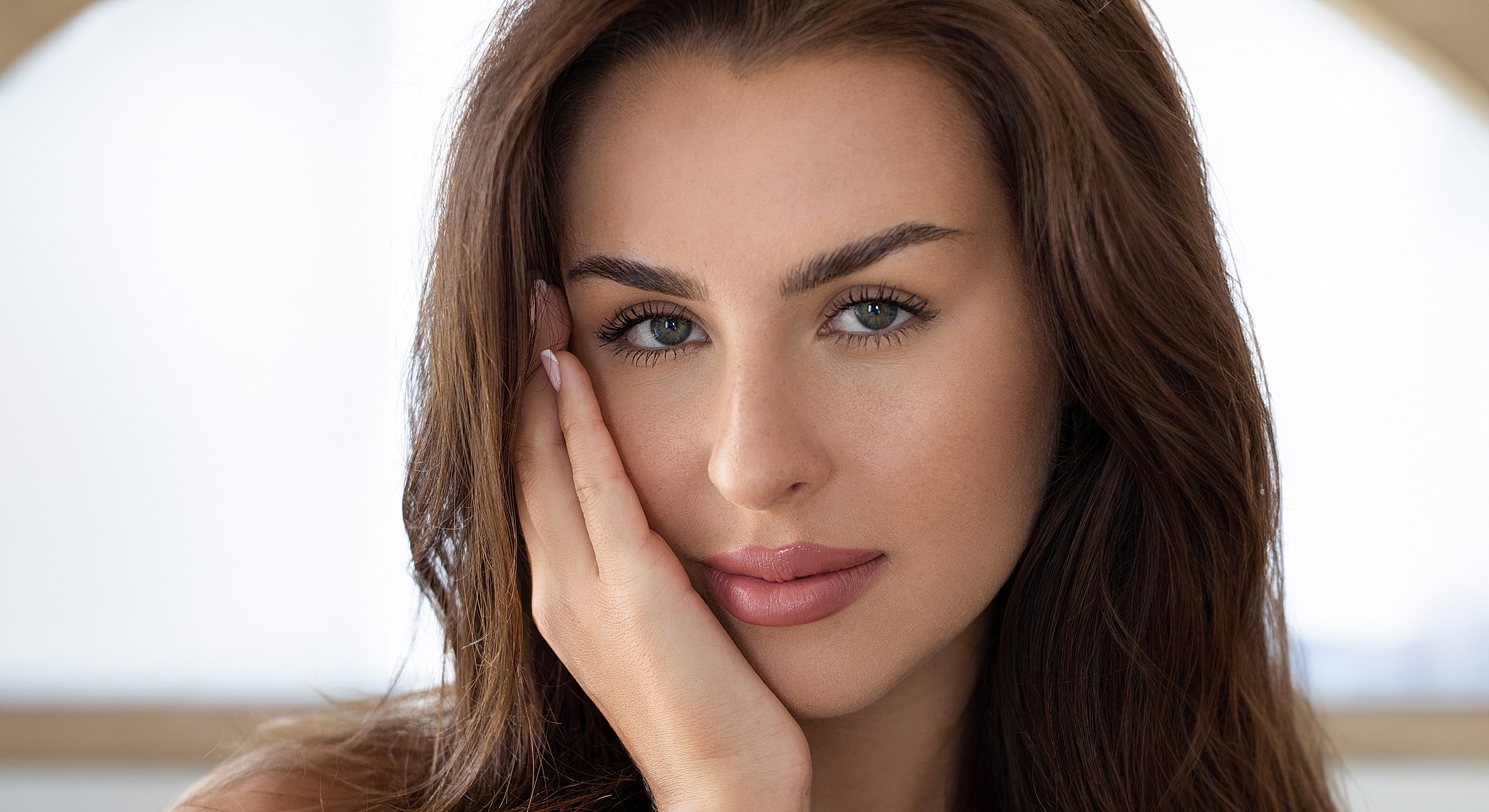 Woman with long hair and striking eyes.