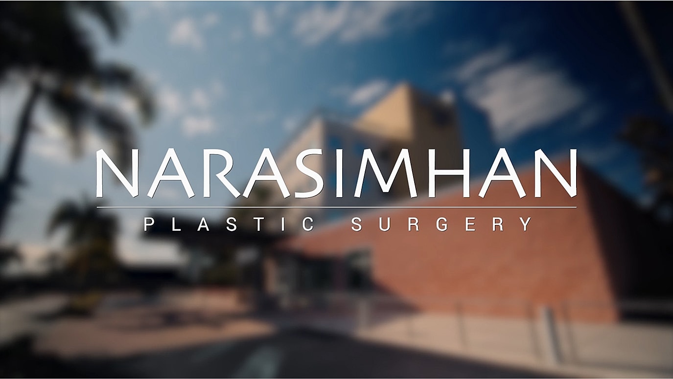 Person speaking in a plant-filled indoor setting.